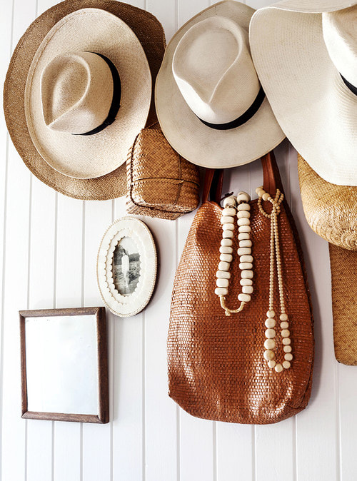 Using hats and combining different textures and elements, Kara Rosenlund has created a beautiful and unique entry space full of style and personality.